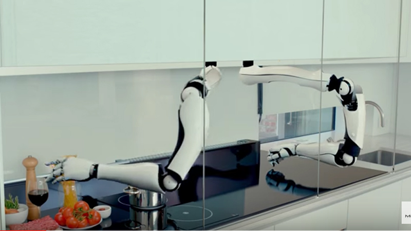 Robot arm cooking in a modern kitchen - Moley demonstrates robotic kitchen unit