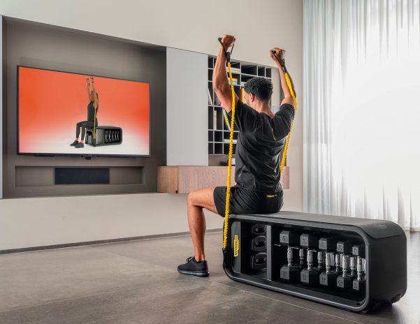 Person exercising in living room with smart TV - Samsung TVs Boost Home Fitness Offerings With Technogym App on ...