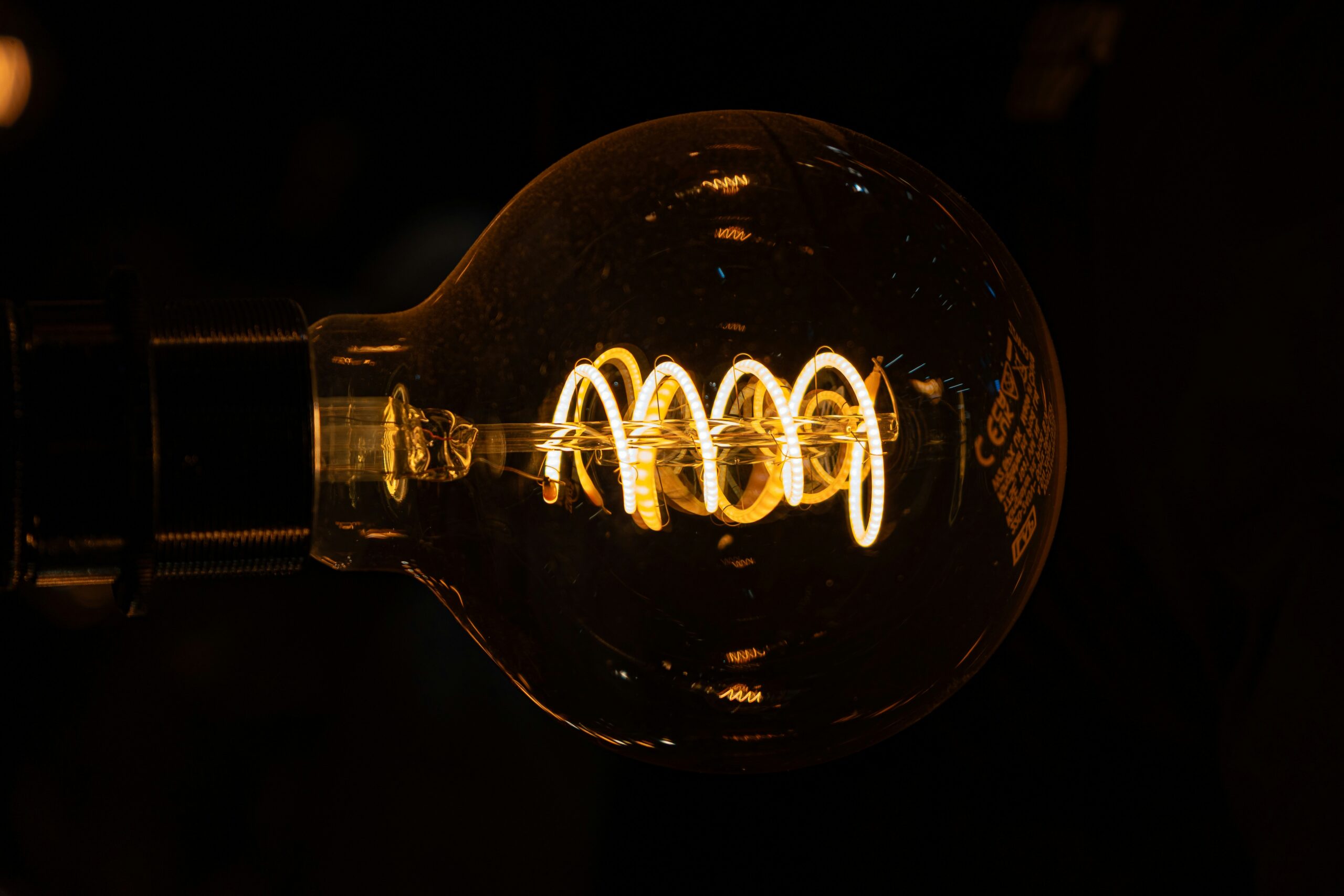 futuristic light bulb with glowing circuits - A close up of a light bulb in the dark
