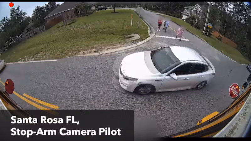 car illegally passing stopped school bus - Florida schools adding cameras to school buses to stop illegal passing
